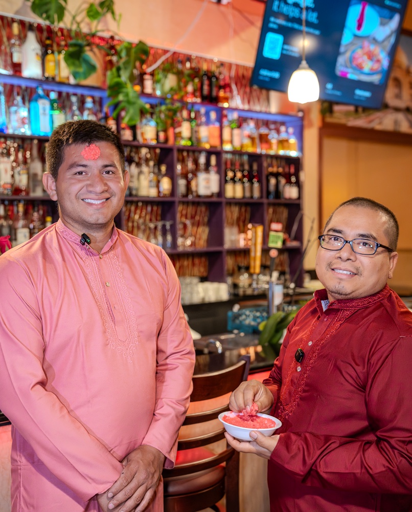 Two of our crew in kurtas, one giving tika from a small bowl