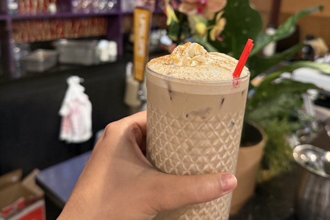 Iced chai with whipped cream and cinnamon